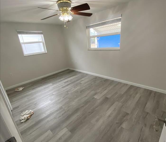 room with white walls, grey floor and white trim