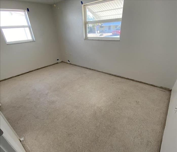 room with white walls and cement flooring
