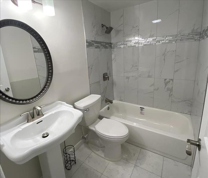 white bathroom with sink, toilet, and shower